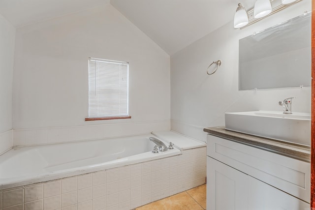 full bathroom with lofted ceiling, a garden tub, vanity, and tile patterned floors