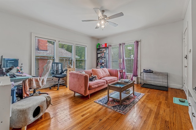 living area featuring a ceiling fan, plenty of natural light, and hardwood / wood-style floors