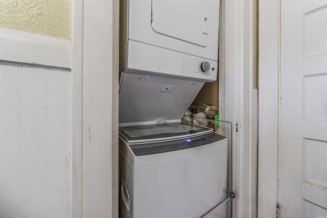 laundry room with stacked washing maching and dryer