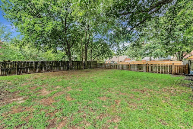 view of yard with a fenced backyard