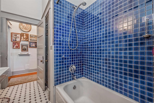 bathroom featuring baseboards and shower / bathing tub combination