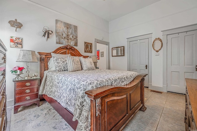 bedroom with light tile patterned flooring