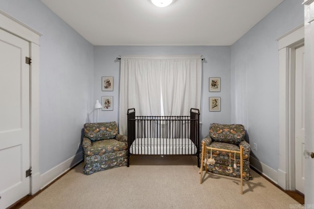 carpeted bedroom featuring baseboards