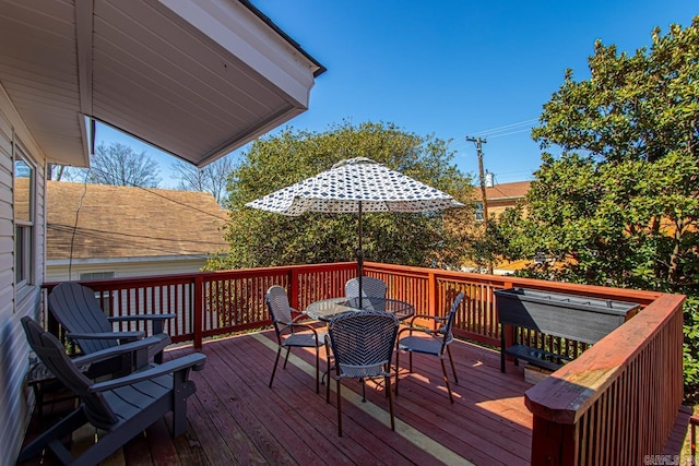 wooden terrace with outdoor dining area