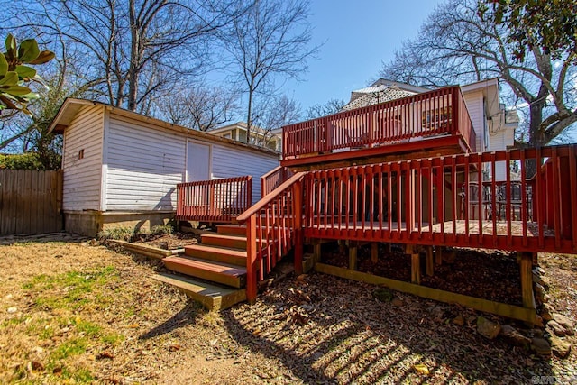 wooden deck featuring fence and an outdoor structure