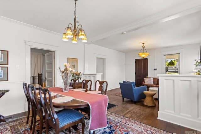 dining space featuring a notable chandelier, crown molding, and wood finished floors