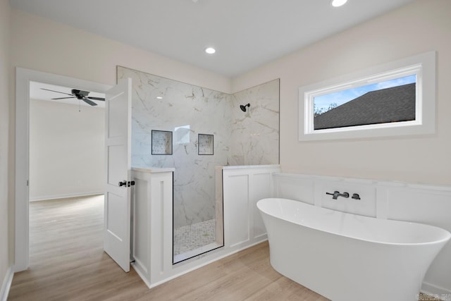 full bath featuring wood finished floors, a soaking tub, a marble finish shower, and recessed lighting