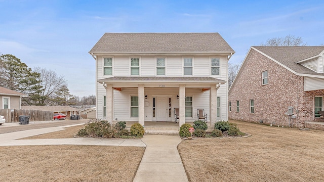 view of front facade with a porch and a shingled roof