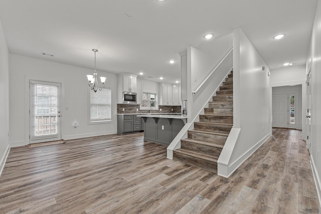 interior space with visible vents, stairway, and wood finished floors