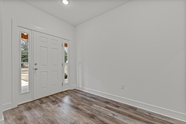 foyer with baseboards and dark wood finished floors