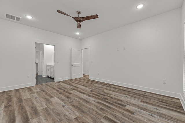 unfurnished bedroom featuring wood finished floors, visible vents, and baseboards