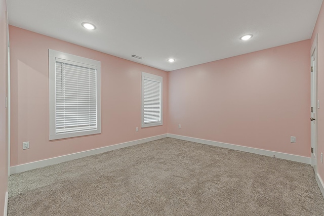 empty room featuring carpet floors and baseboards