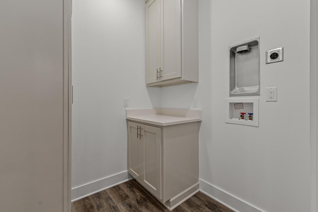 washroom with washer hookup, cabinet space, dark wood-type flooring, hookup for an electric dryer, and baseboards