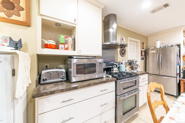 kitchen featuring exhaust hood, visible vents, appliances with stainless steel finishes, dark countertops, and crown molding