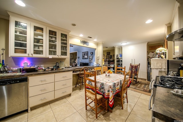 kitchen featuring crown molding, stainless steel appliances, dark countertops, visible vents, and light tile patterned flooring