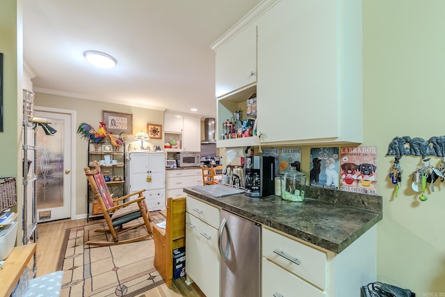 kitchen with white cabinets, dark countertops, ornamental molding, refrigerator, and open shelves