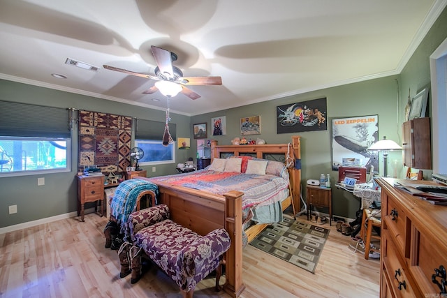 bedroom featuring light wood-style flooring, visible vents, and ornamental molding