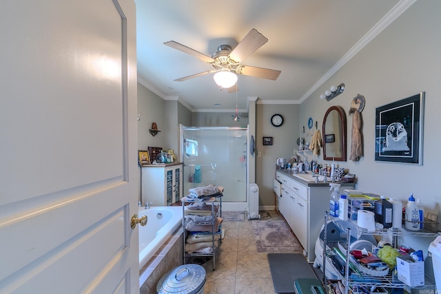 bathroom featuring a stall shower, a garden tub, crown molding, and vanity