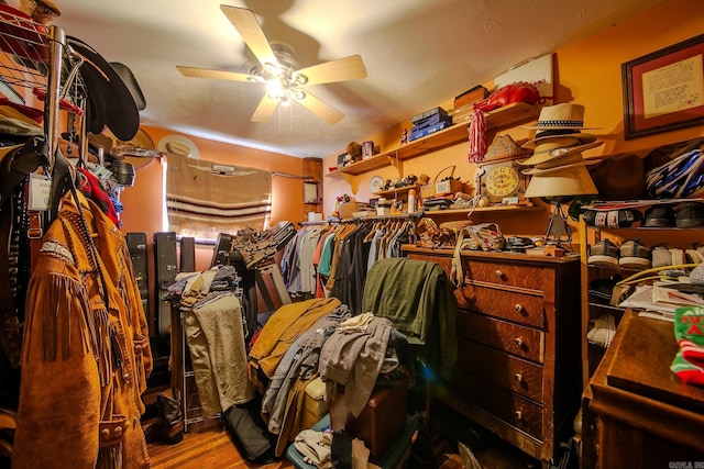 walk in closet featuring ceiling fan and wood finished floors