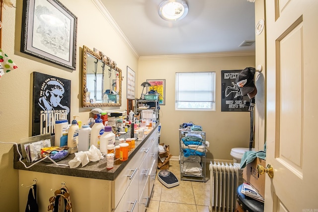 interior space featuring light tile patterned floors, radiator heating unit, visible vents, and crown molding