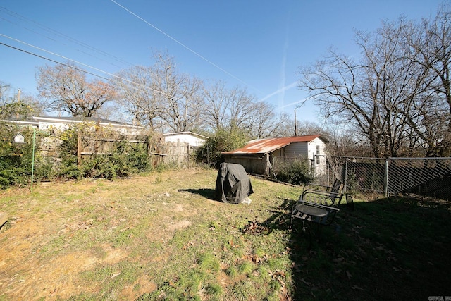 view of yard featuring an outbuilding and fence