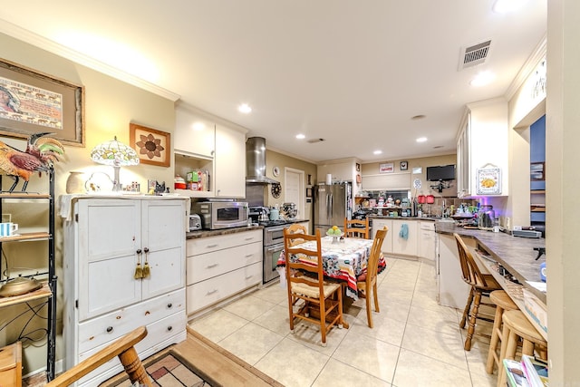 dining area featuring visible vents, crown molding, and light tile patterned floors