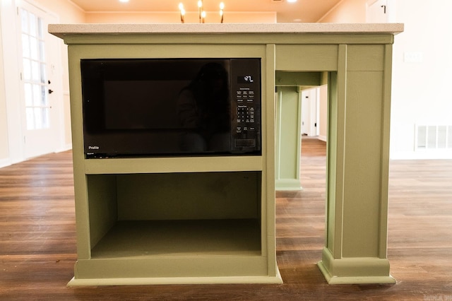 room details with visible vents and wood finished floors