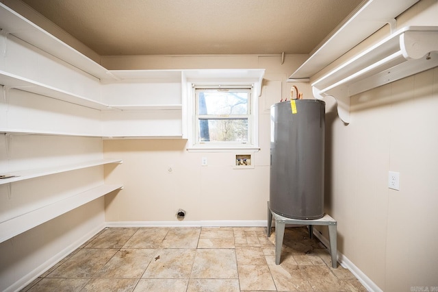 laundry area featuring washer hookup, water heater, hookup for an electric dryer, laundry area, and baseboards