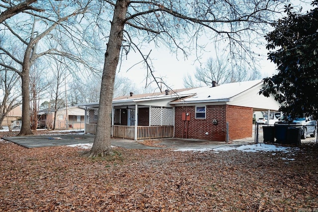 rear view of house featuring brick siding