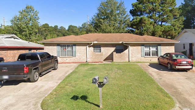 view of front of home featuring a front yard and brick siding