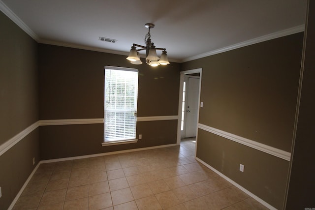 tiled spare room featuring baseboards, visible vents, a chandelier, and crown molding