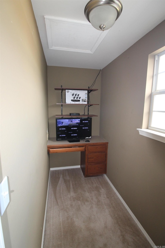 office area featuring light carpet and baseboards