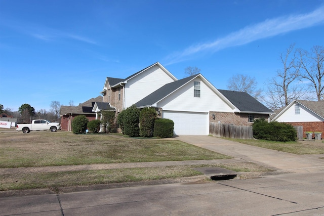 view of property exterior featuring an attached garage, brick siding, fence, driveway, and a lawn