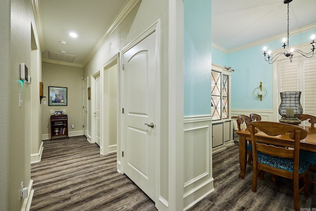 hallway featuring a wainscoted wall, dark wood-type flooring, and crown molding