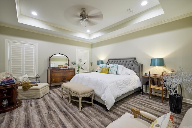 bedroom featuring a tray ceiling, visible vents, and recessed lighting