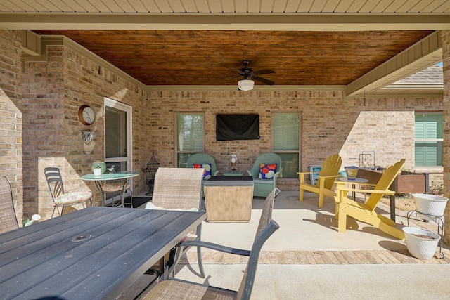 view of patio with outdoor dining area and ceiling fan