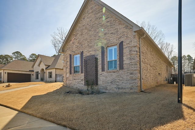 view of side of property featuring brick siding