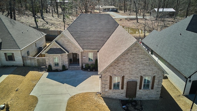 view of front of house with brick siding and fence