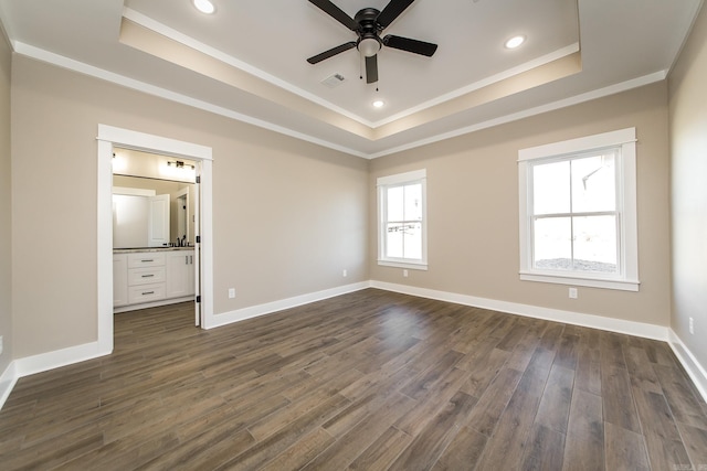 unfurnished bedroom with dark wood-type flooring, a raised ceiling, and visible vents