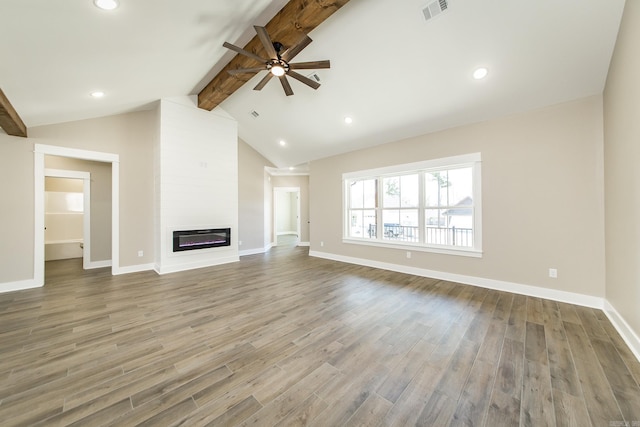 unfurnished living room featuring vaulted ceiling with beams, a large fireplace, wood finished floors, a ceiling fan, and visible vents