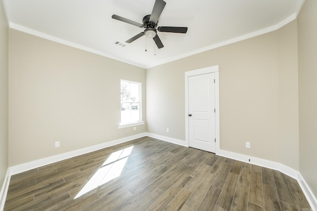 empty room featuring wood finished floors, a ceiling fan, visible vents, baseboards, and ornamental molding