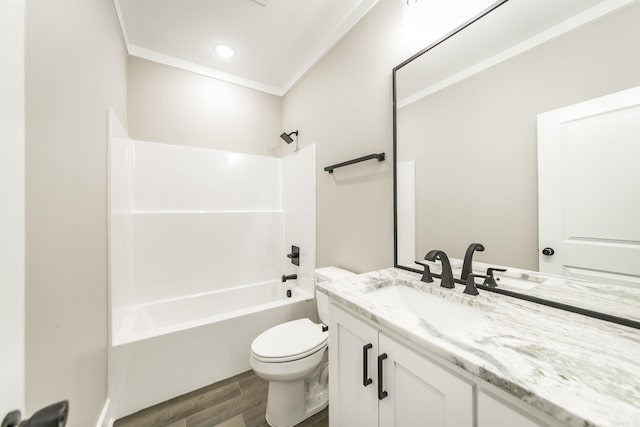 bathroom with crown molding, toilet, vanity, wood finished floors, and  shower combination