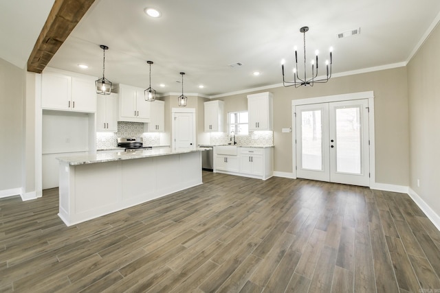 kitchen featuring appliances with stainless steel finishes, decorative backsplash, visible vents, and white cabinets