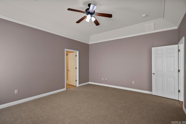 carpeted empty room with ceiling fan, ornamental molding, lofted ceiling, and baseboards