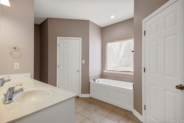 bathroom with a bath, tile patterned flooring, baseboards, and a sink