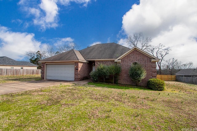 single story home featuring driveway, a garage, brick siding, fence, and a front yard