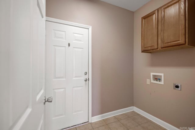 clothes washing area featuring cabinet space, baseboards, hookup for a washing machine, hookup for an electric dryer, and light tile patterned flooring