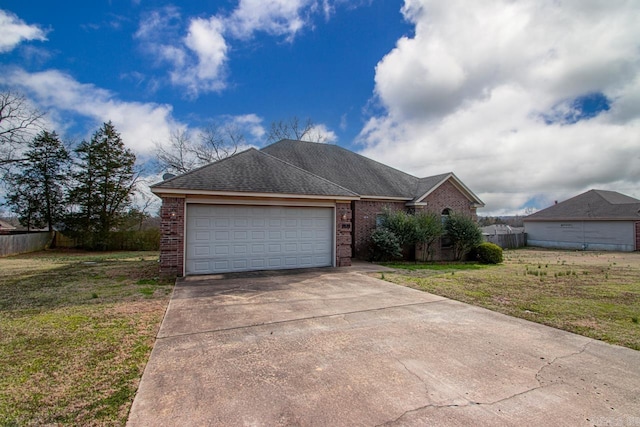 ranch-style house featuring concrete driveway, a front lawn, fence, and brick siding