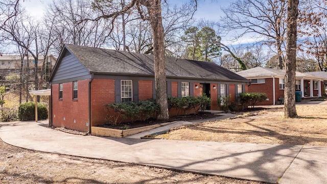 ranch-style house featuring driveway, brick siding, crawl space, and a shingled roof