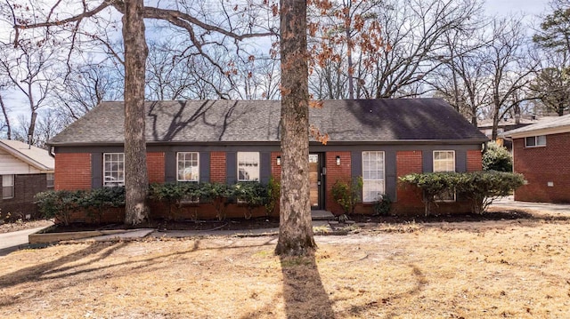 ranch-style house with brick siding and a shingled roof